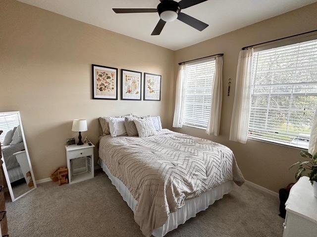 bedroom featuring ceiling fan and carpet flooring