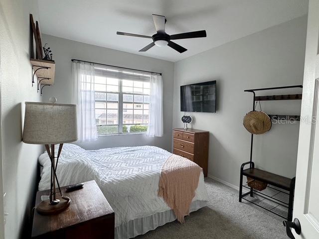 carpeted bedroom with ceiling fan