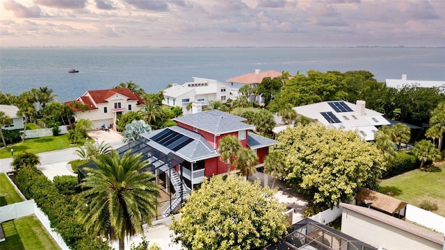 aerial view at dusk featuring a water view