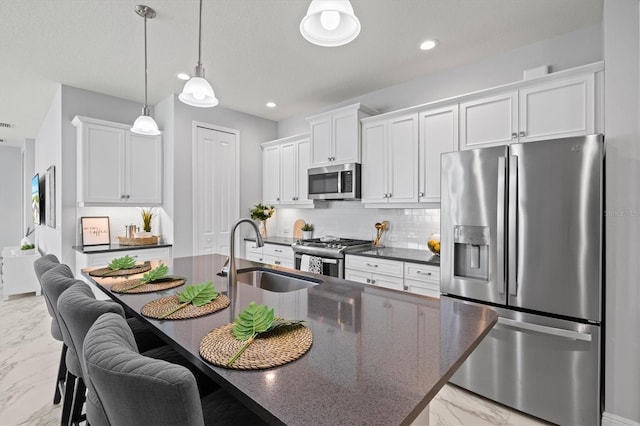 kitchen featuring white cabinetry, backsplash, sink, and stainless steel appliances