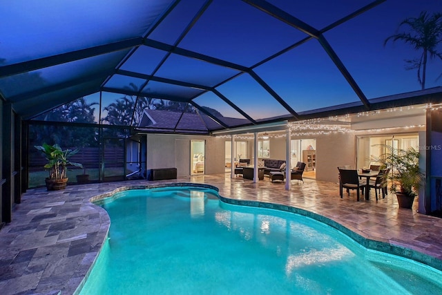 view of pool featuring a lanai, an outdoor hangout area, and a patio area