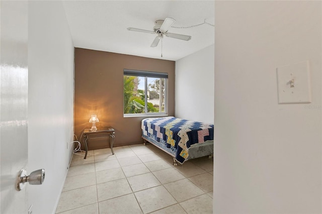 bedroom with ceiling fan and light tile patterned floors