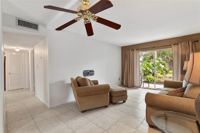 living room with a textured ceiling and ceiling fan