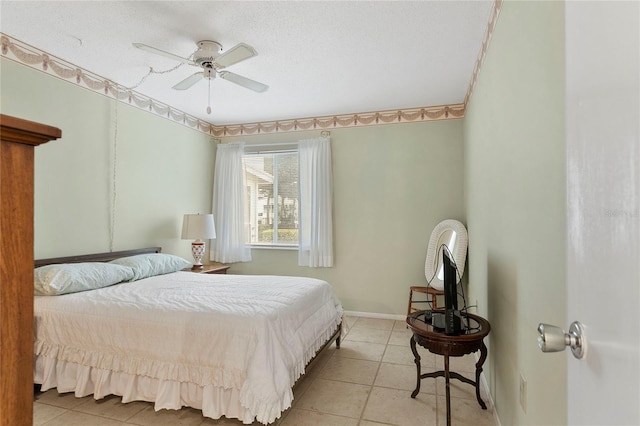 bedroom featuring a textured ceiling, ceiling fan, and light tile patterned flooring