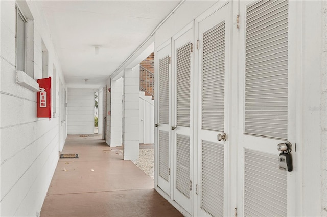 hall featuring concrete floors