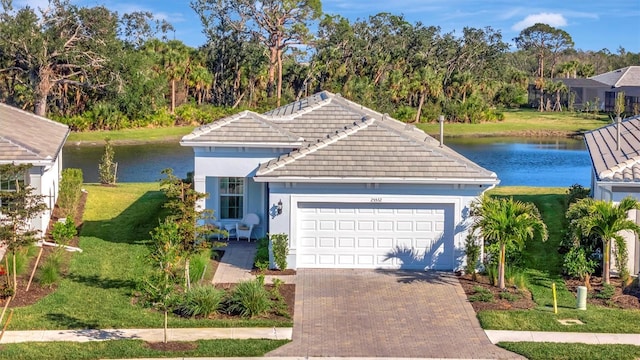 view of front of house with a garage, a water view, and a front yard