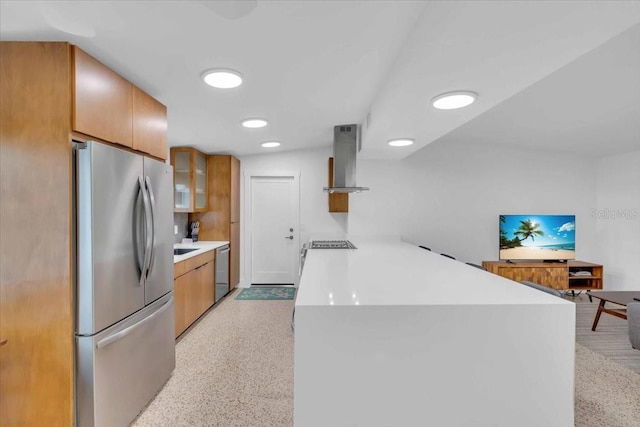 kitchen featuring island exhaust hood, appliances with stainless steel finishes, and kitchen peninsula