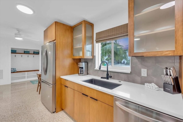 kitchen with ceiling fan, stainless steel appliances, tasteful backsplash, and sink