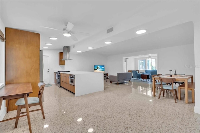 kitchen with ceiling fan, appliances with stainless steel finishes, and extractor fan