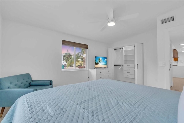 bedroom featuring ceiling fan, a closet, and a spacious closet