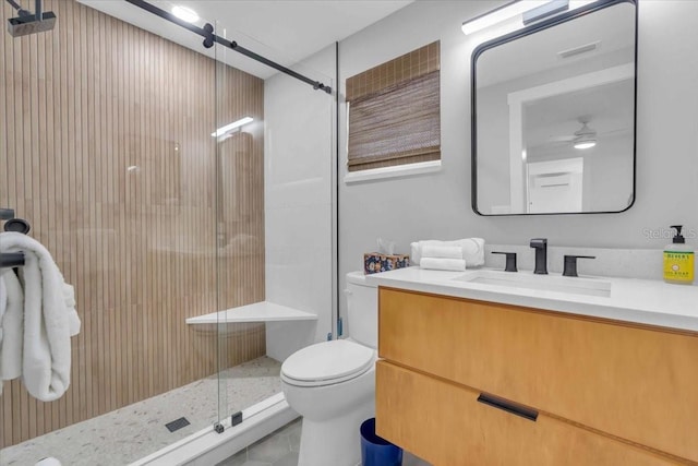 bathroom with ceiling fan, toilet, vanity, and an enclosed shower