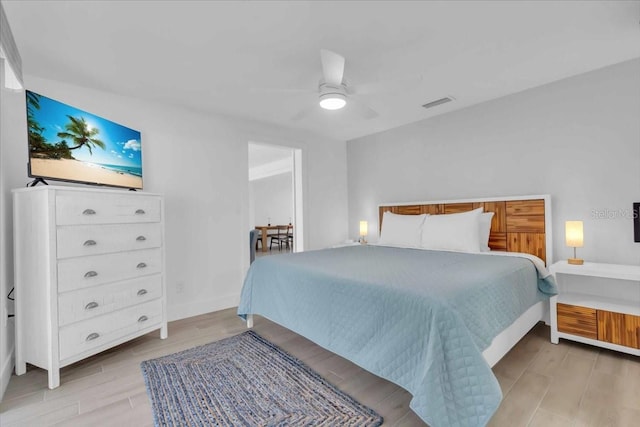 bedroom with ceiling fan and light hardwood / wood-style flooring