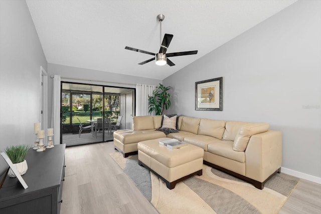 living room with vaulted ceiling, light hardwood / wood-style floors, and ceiling fan