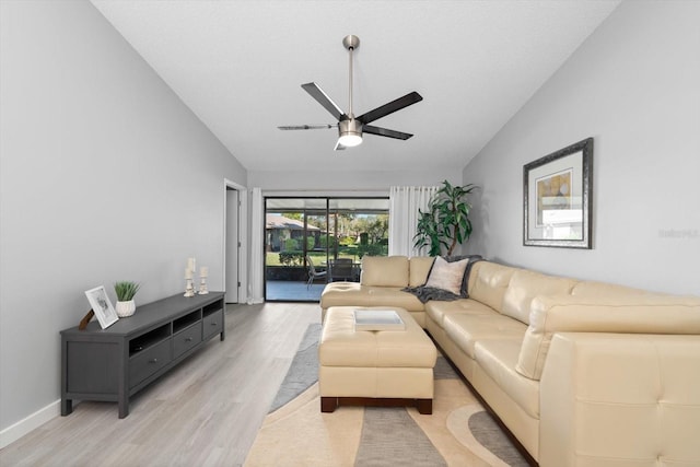 living room featuring ceiling fan, vaulted ceiling, and light hardwood / wood-style flooring