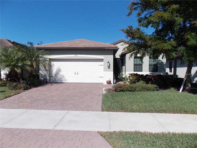 single story home with a garage and a front yard