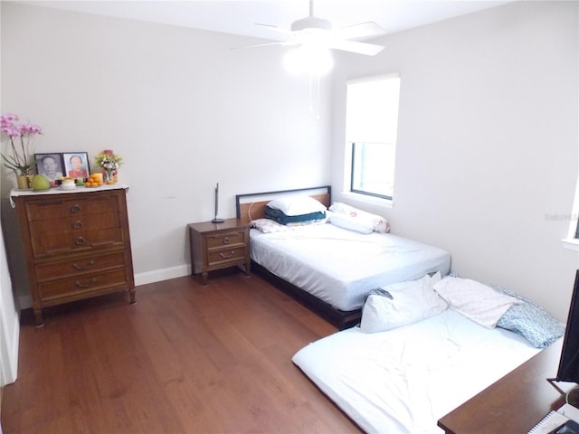 bedroom featuring ceiling fan and dark hardwood / wood-style flooring