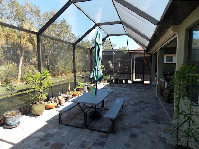 view of patio / terrace featuring glass enclosure