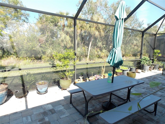 view of patio featuring a lanai