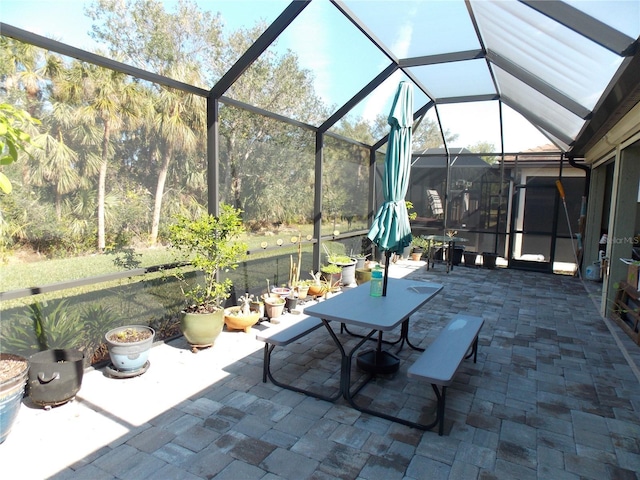 view of patio featuring a lanai