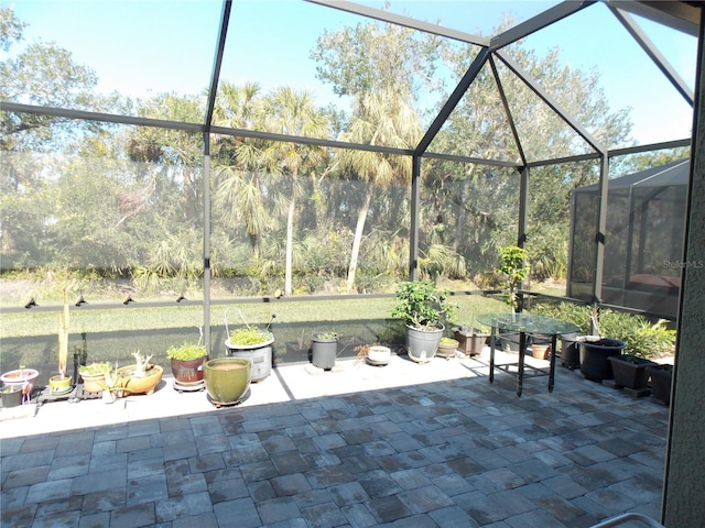 view of patio with glass enclosure