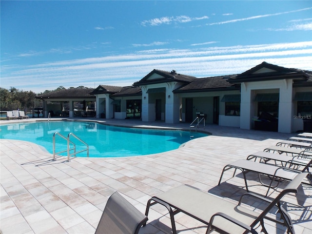 view of swimming pool with a patio