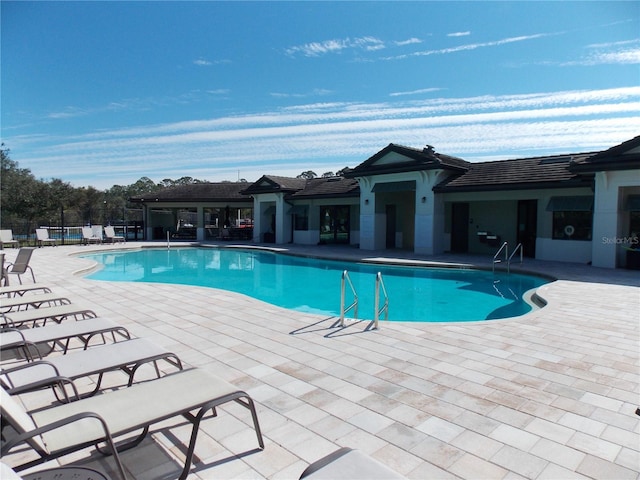 view of swimming pool featuring a patio area