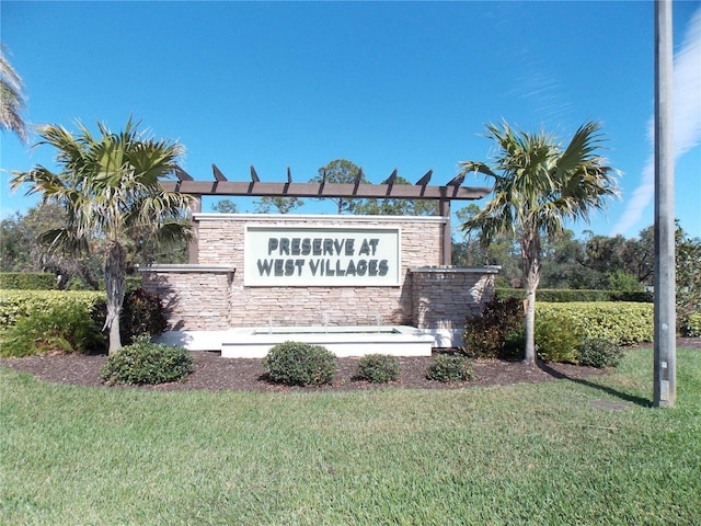 community / neighborhood sign featuring a yard