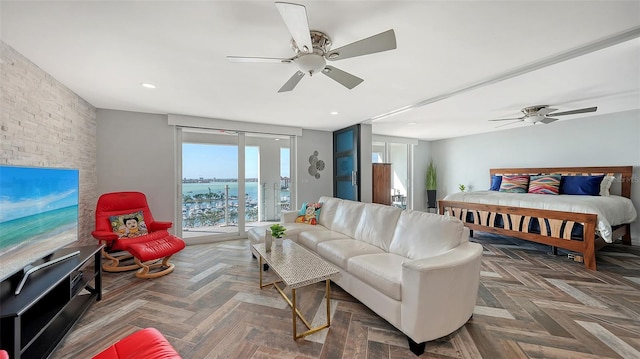 bedroom with access to exterior, dark parquet flooring, and ceiling fan