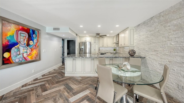 dining room with dark parquet floors and ceiling fan