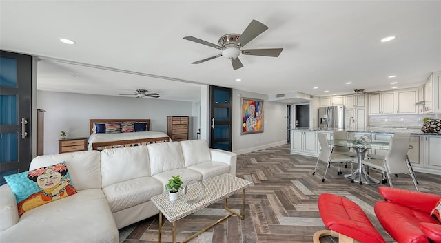 living room featuring dark parquet flooring, sink, and ceiling fan