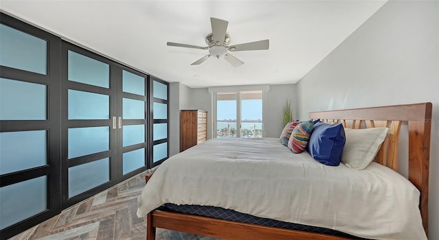 bedroom featuring parquet flooring and ceiling fan