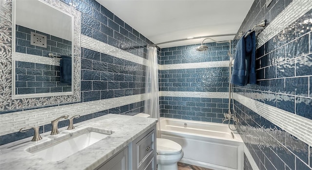 full bathroom with tasteful backsplash, tile walls, vanity, toilet, and shower / bath combo with shower curtain