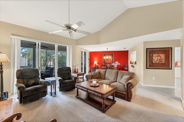 living area with light carpet, high vaulted ceiling, baseboards, and ceiling fan with notable chandelier