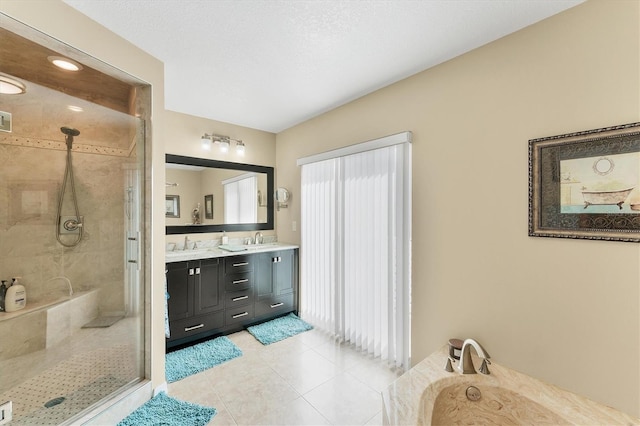 bathroom featuring double vanity, a stall shower, tile patterned floors, a sink, and a bath