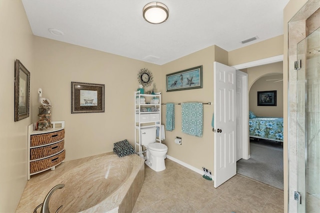 ensuite bathroom featuring visible vents, toilet, a shower stall, ensuite bath, and tile patterned flooring