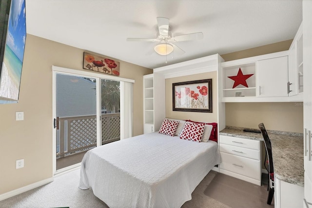 bedroom with baseboards, a ceiling fan, access to exterior, dark colored carpet, and built in desk