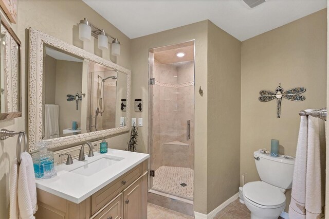 full bathroom with tile patterned flooring, toilet, vanity, baseboards, and a stall shower