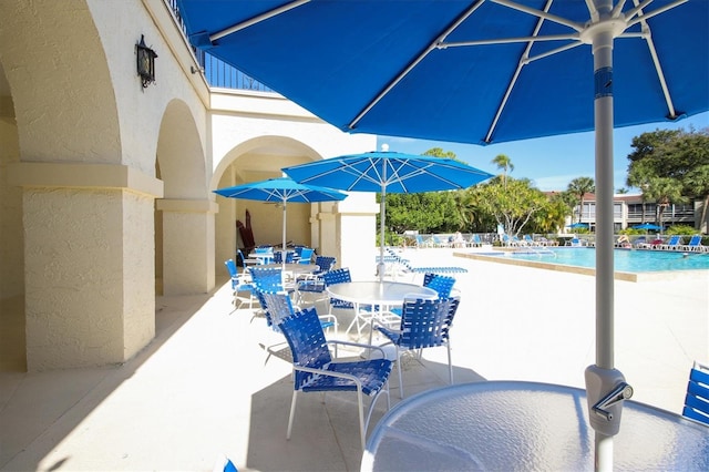 view of patio / terrace with outdoor dining space and a community pool