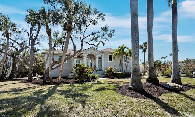 view of front of property featuring a front lawn and stucco siding