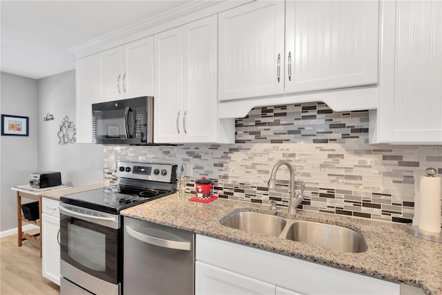 kitchen featuring white cabinetry, appliances with stainless steel finishes, sink, and backsplash