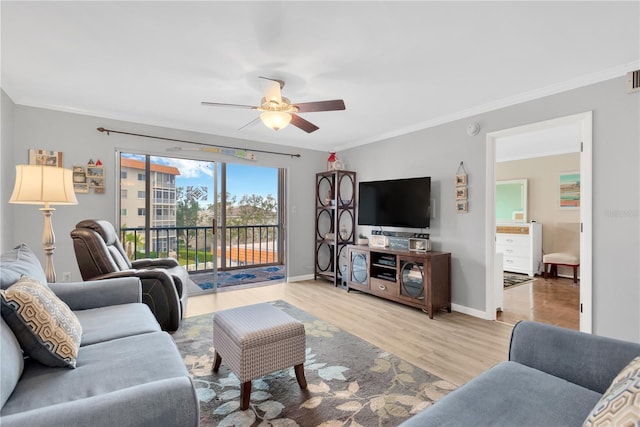 living room with crown molding, ceiling fan, and light wood-type flooring