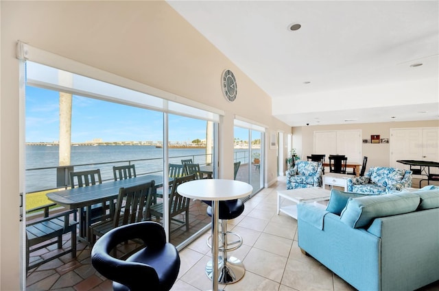 tiled living room featuring a water view