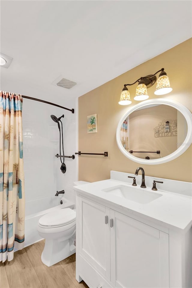 full bathroom with vanity, hardwood / wood-style floors, toilet, and shower / bath combo with shower curtain