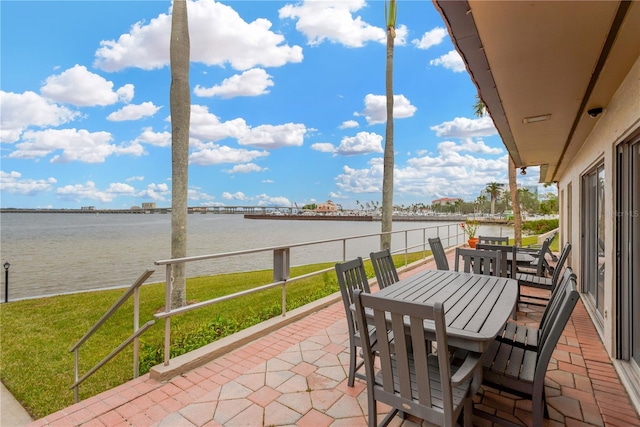 sunroom / solarium featuring a water view