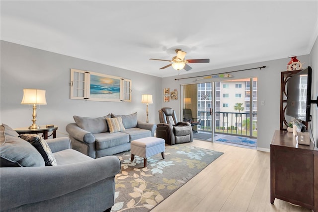 1600 1st Ave W Unit 304A, Bradenton, FL 34205 - living room with a ceiling fan, light wood-style flooring, ornamental molding, and baseboards