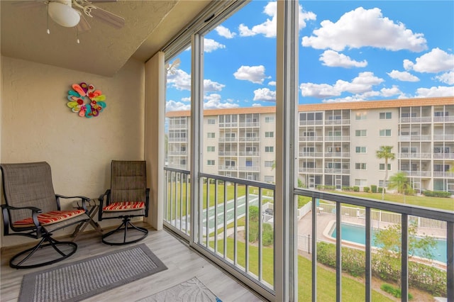 1600 1st Ave W Unit 304A, Bradenton, FL 34205 - balcony with a ceiling fan and view of pool