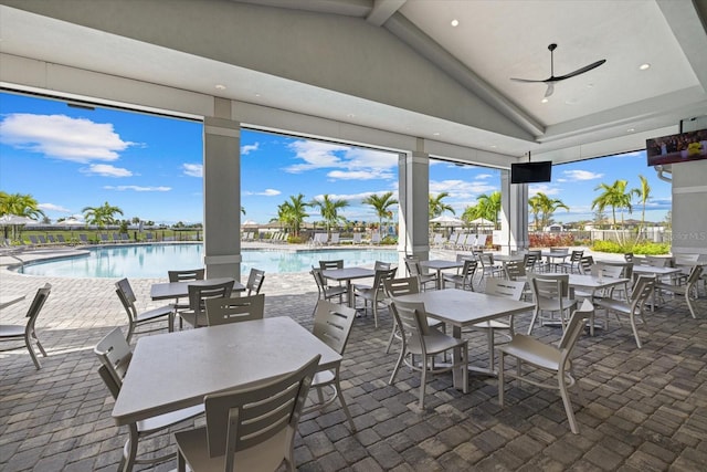 view of patio / terrace featuring ceiling fan, outdoor dining space, and a community pool