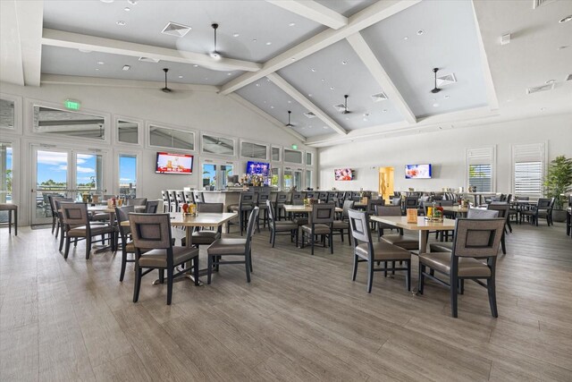 dining area featuring a wealth of natural light, visible vents, and beam ceiling