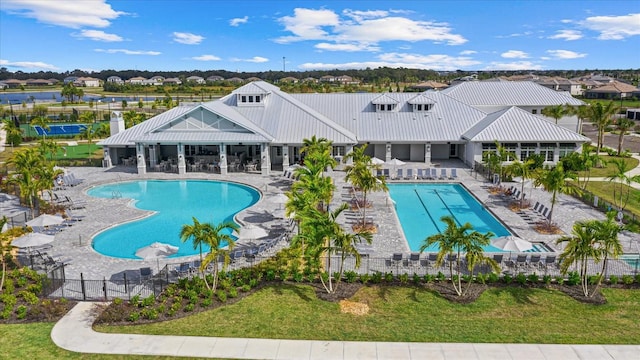 pool with fence, a lawn, and a patio