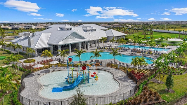 community pool with a water play area and fence